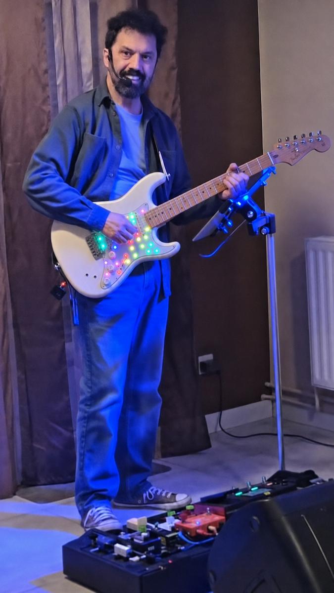 FirstlyMusic founder playing guitar